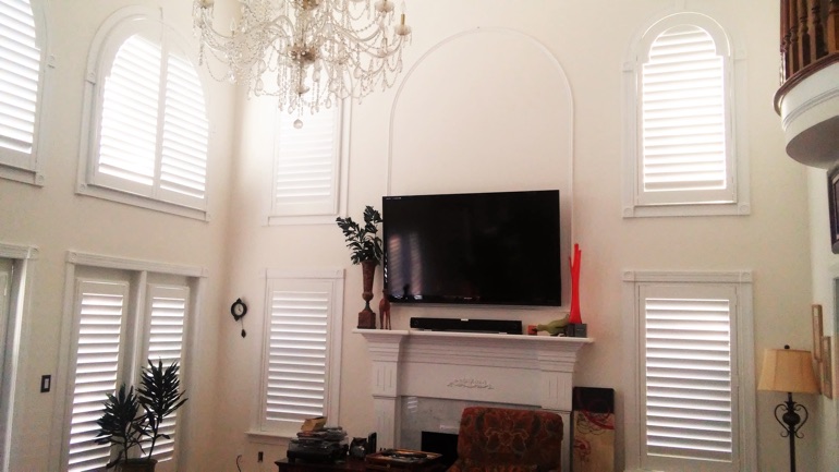 Philadelphia great room with mounted television and high-ceiling windows.